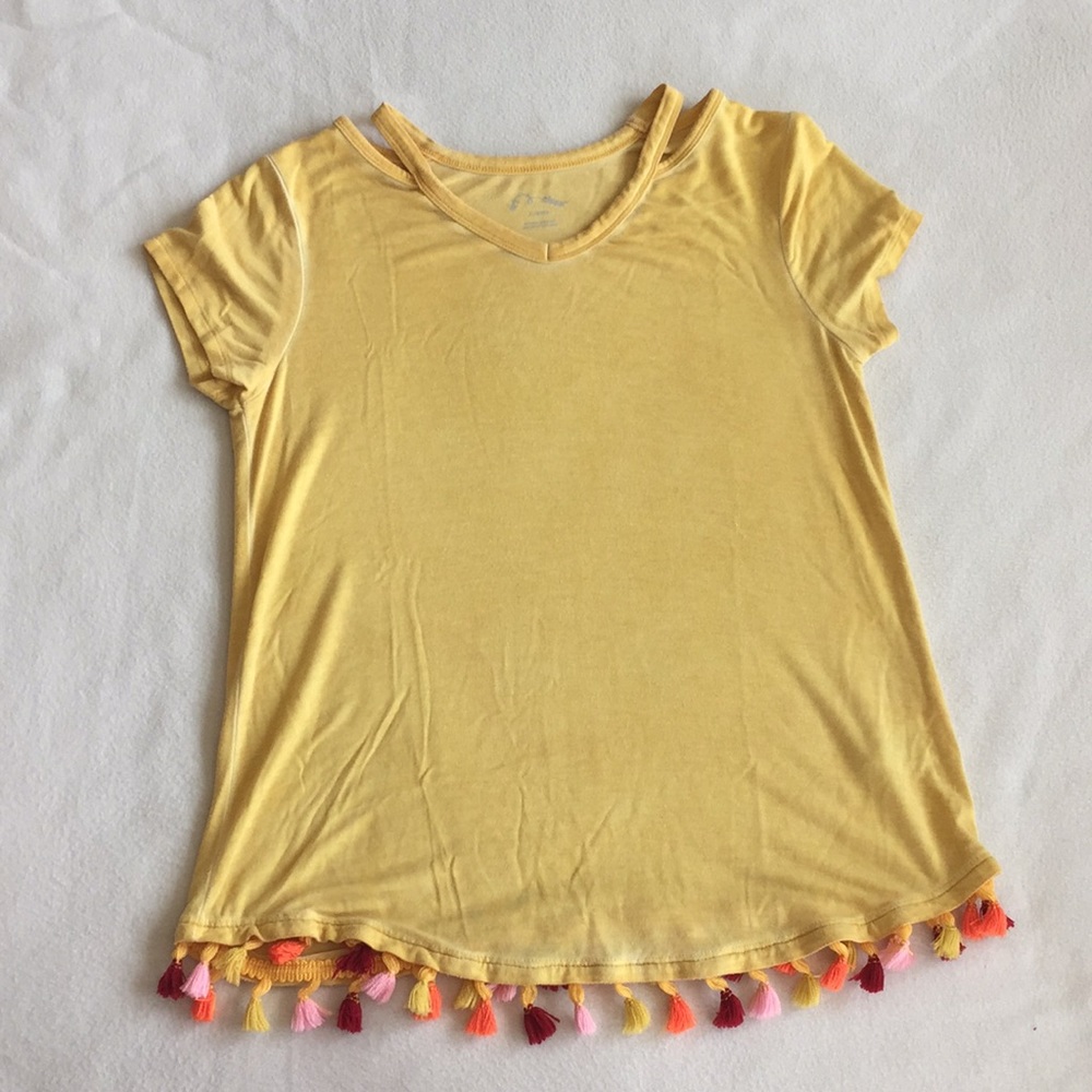 A cream yellow tee with bright tassels